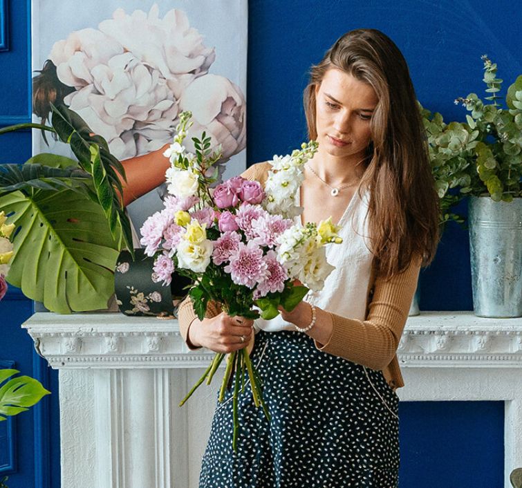 Florystka w kwiaciarni robi bukiet